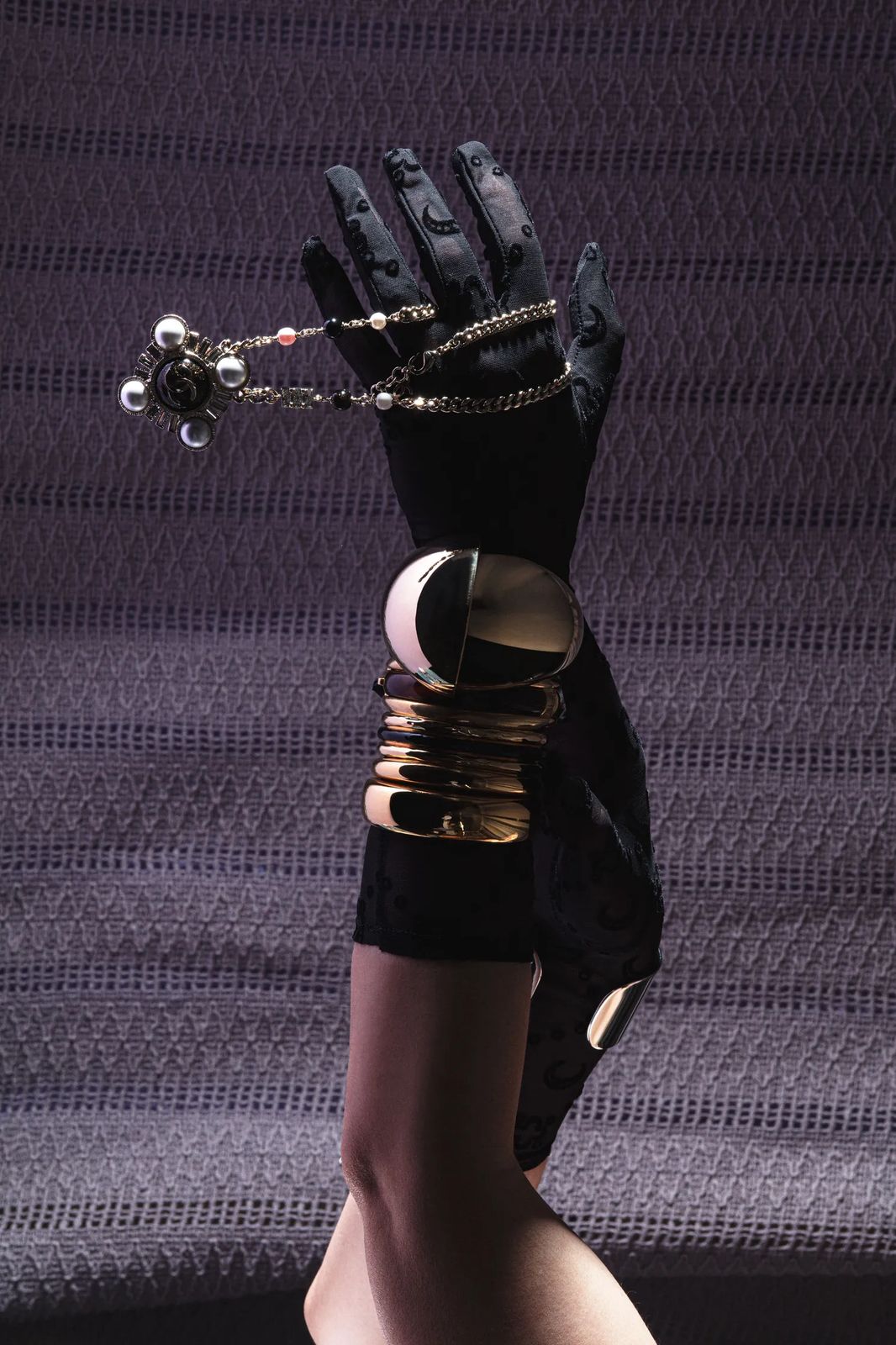 Gloved arm with rings